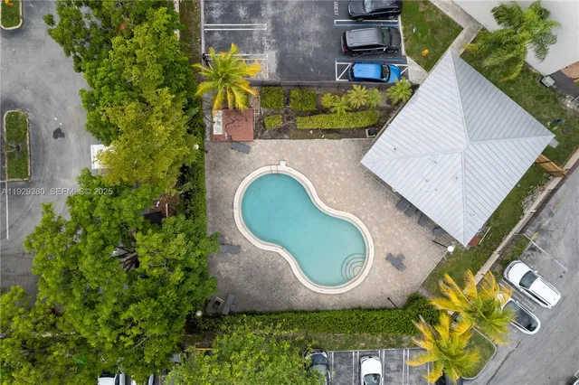 an aerial view of a house with garden space and sitting area