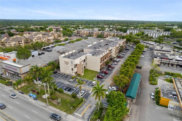 an aerial view of multiple houses with yard