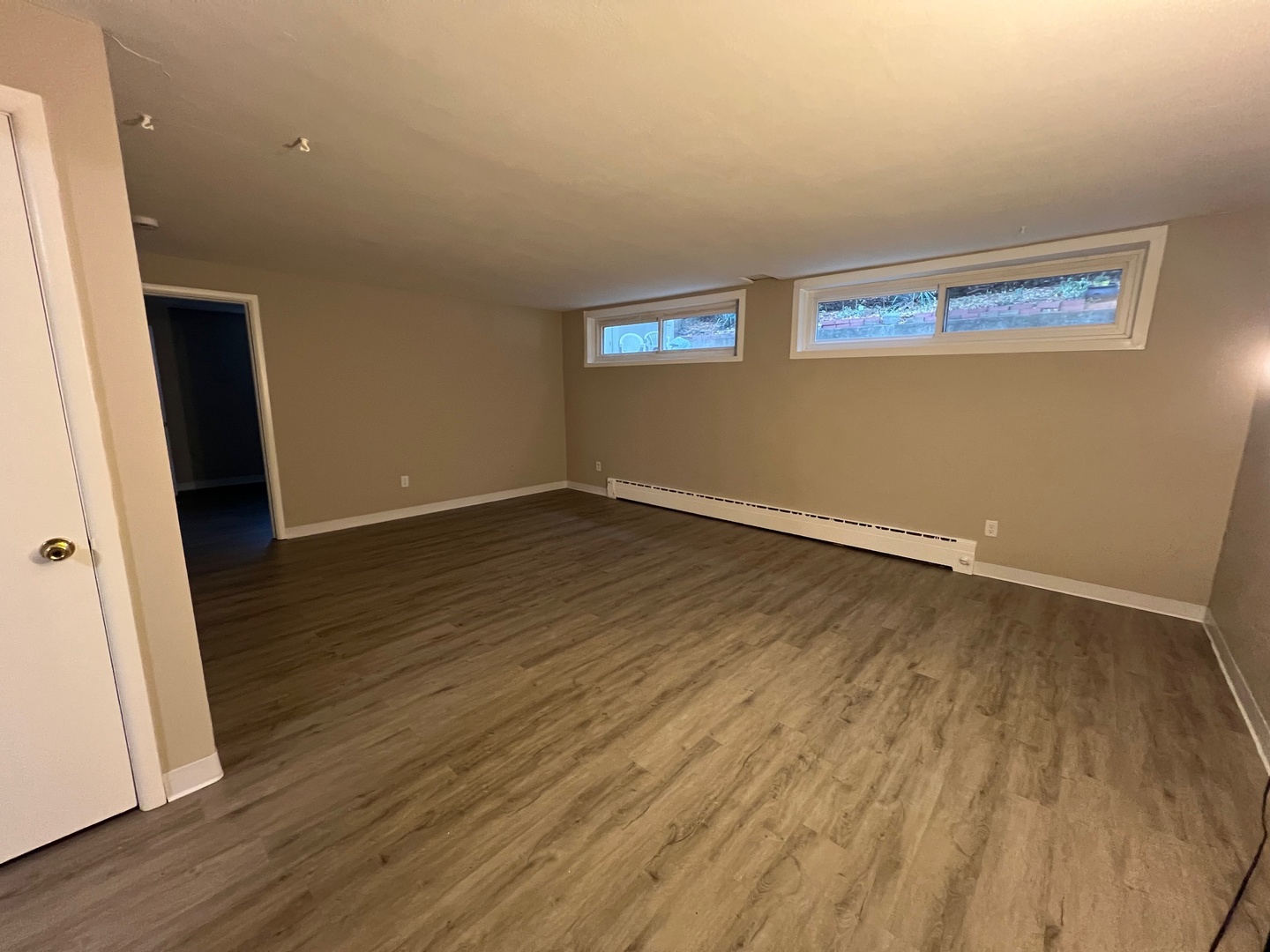 2410 Auburn Street, Unit 2 Rockford, IL 61103 - Photo 2 of 9 an empty room with wooden floor and windows