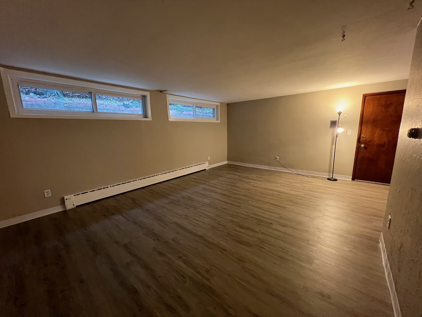 2410 Auburn Street, Unit 2 Rockford, IL 61103 - Photo 3 of 9 a view of an empty room with wooden floor and a window
