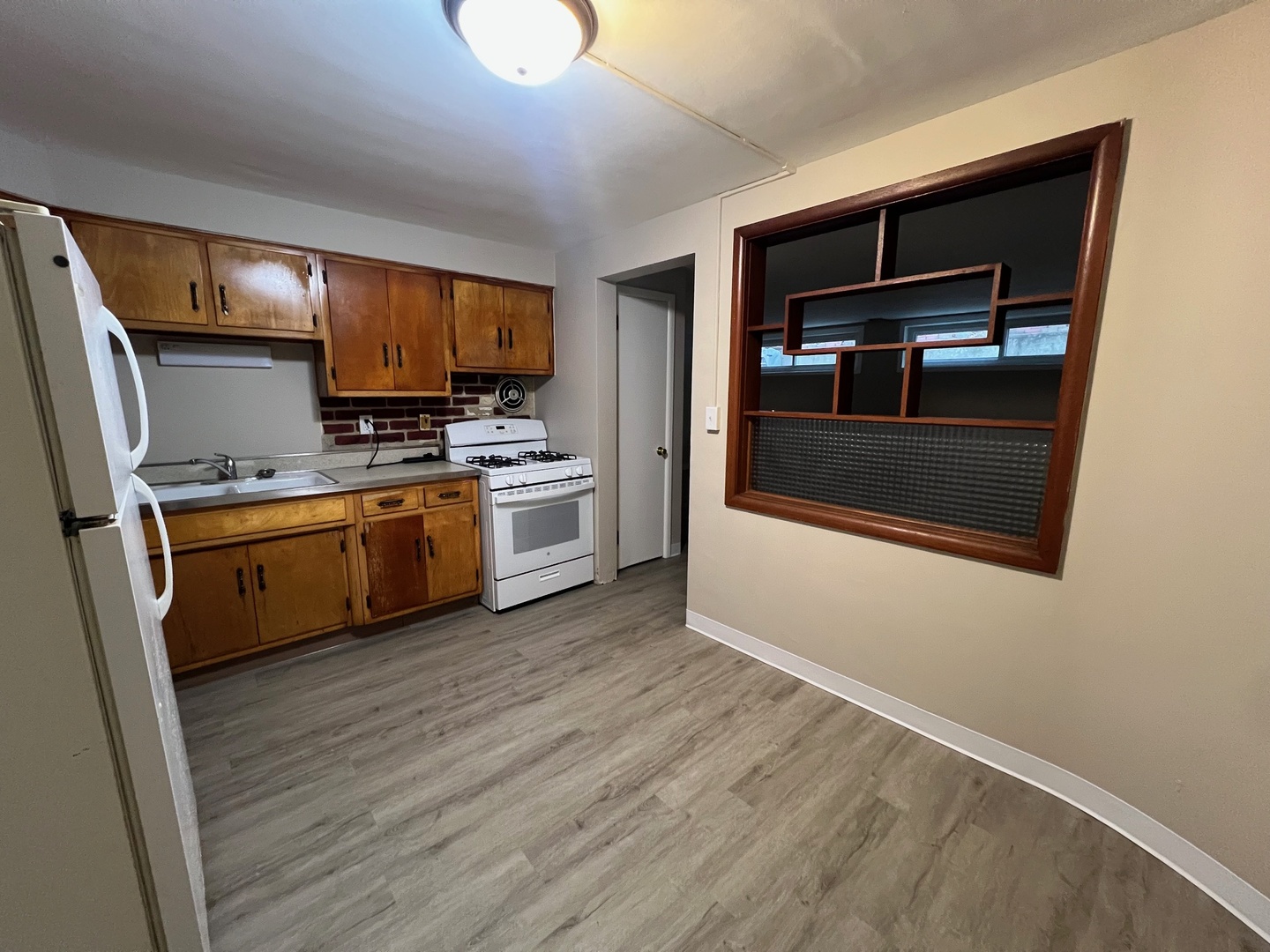 2410 Auburn Street, Unit 2 Rockford, IL 61103 - Photo 4 of 9 a kitchen with a sink a microwave and cabinets