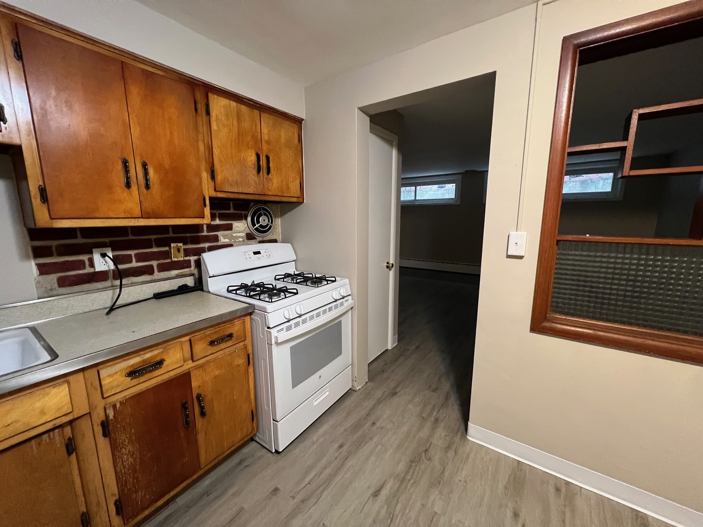 2410 Auburn Street, Unit 2 Rockford, IL 61103 - Photo 5 of 9 a kitchen with stainless steel appliances a stove a microwave and wooden floors