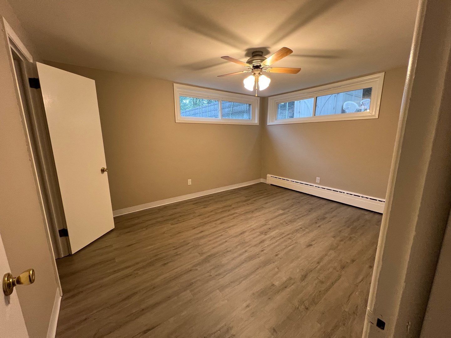 2410 Auburn Street, Unit 2 Rockford, IL 61103 - Photo 6 of 9 an empty room with wooden floor and fan