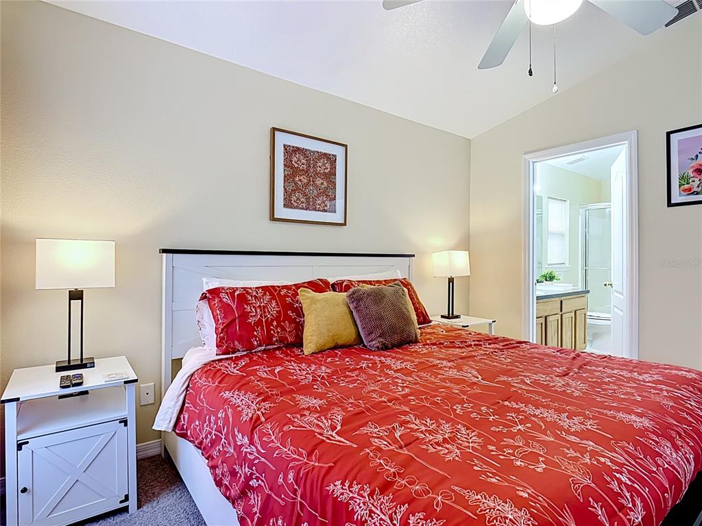 522 Sandy Ridge Drive Davenport, FL 33896 - Photo 17 of 34 a bedroom with a bed and a table