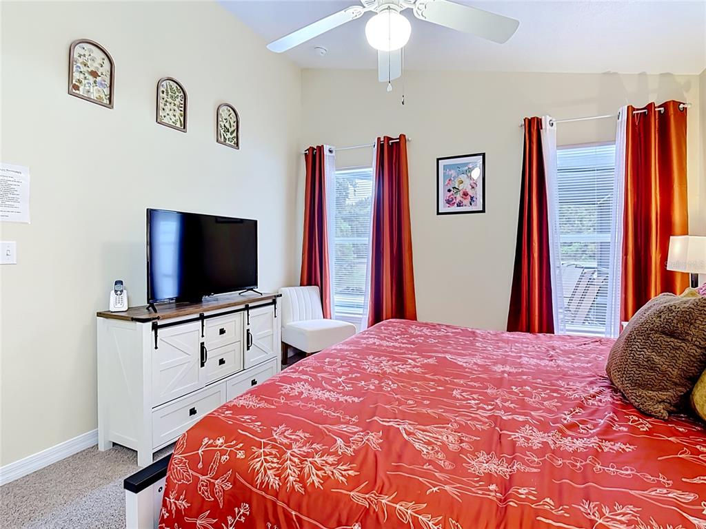 522 Sandy Ridge Drive Davenport, FL 33896 - Photo 18 of 34 a bedroom with a bed and a flat screen tv