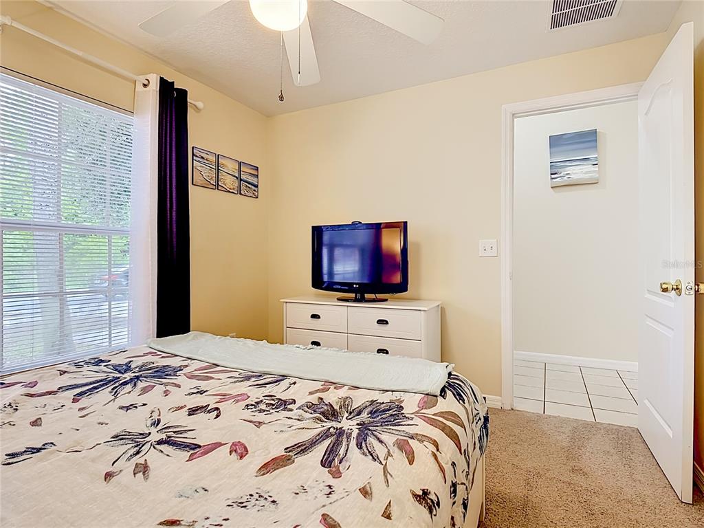 522 Sandy Ridge Drive Davenport, FL 33896 - Photo 24 of 34 a bedroom with a bed and a flat screen tv
