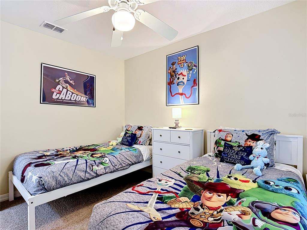 522 Sandy Ridge Drive Davenport, FL 33896 - Photo 27 of 34 a bedroom with two beds and a couch