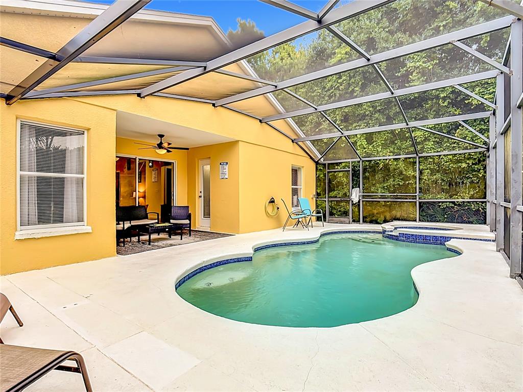 522 Sandy Ridge Drive Davenport, FL 33896 - Photo 3 of 34 a view of a swimming pool with a patio