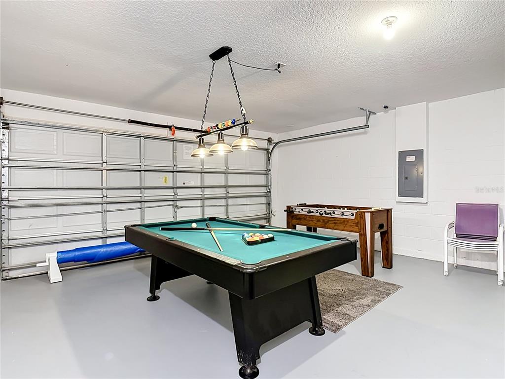 522 Sandy Ridge Drive Davenport, FL 33896 - Photo 32 of 34 a room with pool table and a chandelier