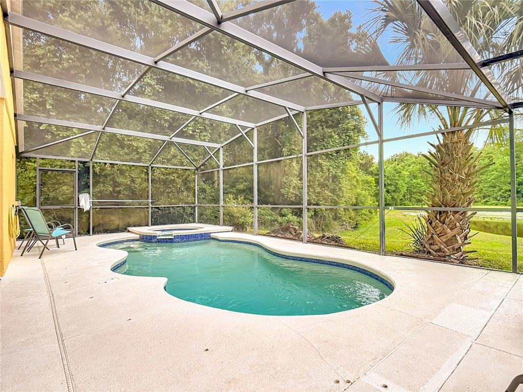 522 Sandy Ridge Drive Davenport, FL 33896 - Photo 5 of 34 a view of a swimming pool with an outdoor seating
