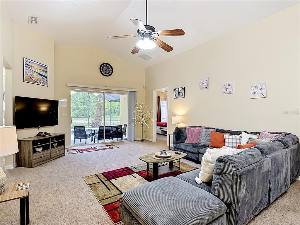 522 Sandy Ridge Drive Davenport, FL 33896 - Photo 7 of 34 a living room with furniture and a flat screen tv