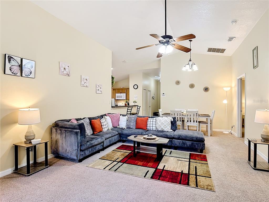 522 Sandy Ridge Drive Davenport, FL 33896 - Photo 8 of 34 a living room with furniture a rug and lamp