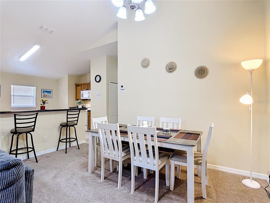 522 Sandy Ridge Drive Davenport, FL 33896 - Photo 9 of 34 a view of a dining room with furniture and chandelier