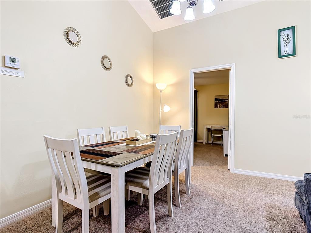 522 Sandy Ridge Drive Davenport, FL 33896 - Photo 10 of 34 a view of a dining room with furniture and wooden floor