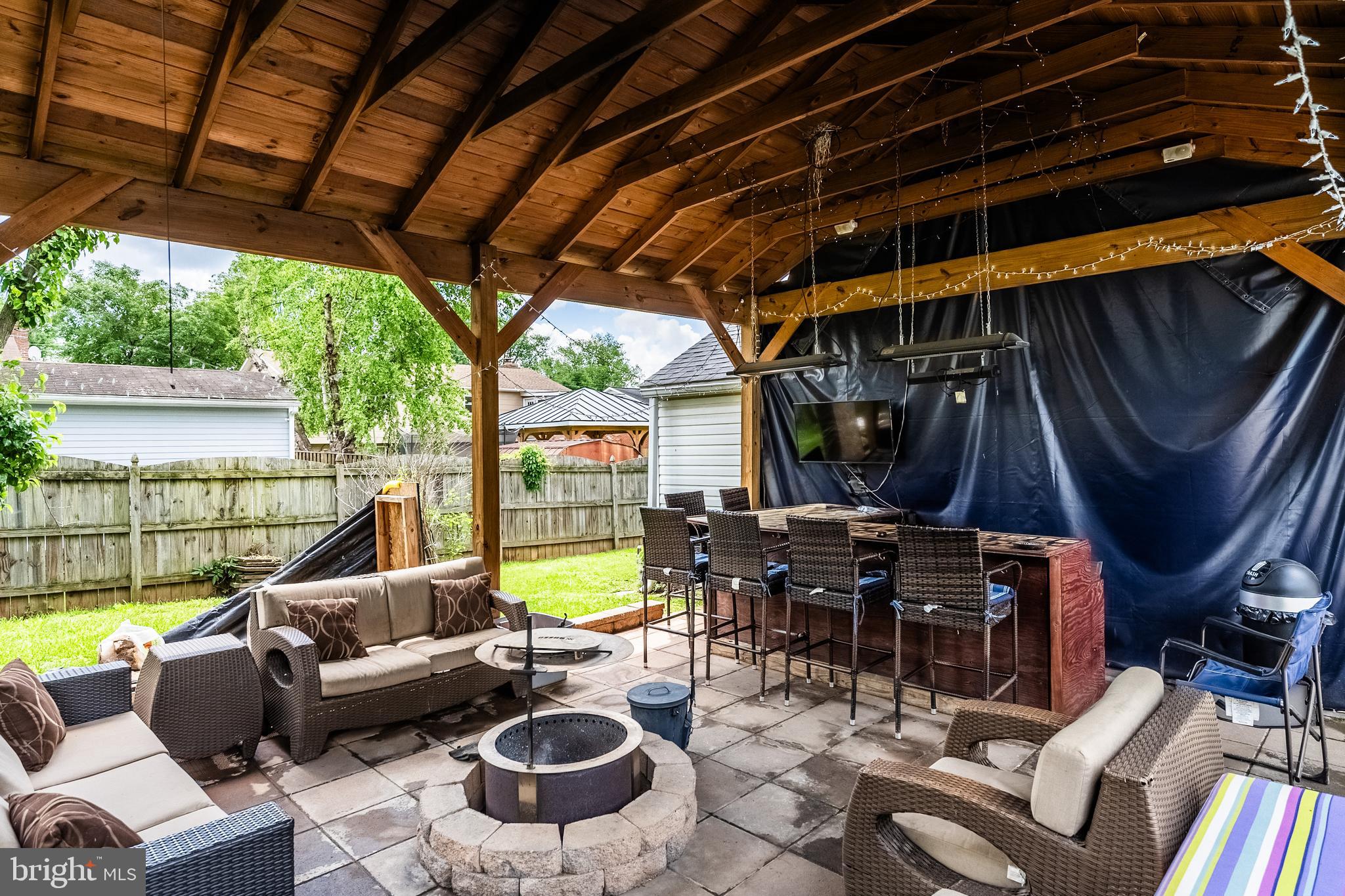 9722 Copeland Drive Manassas, VA 20109 - Photo 11 of 46 a view of a patio with couches chairs and a large umbrella
