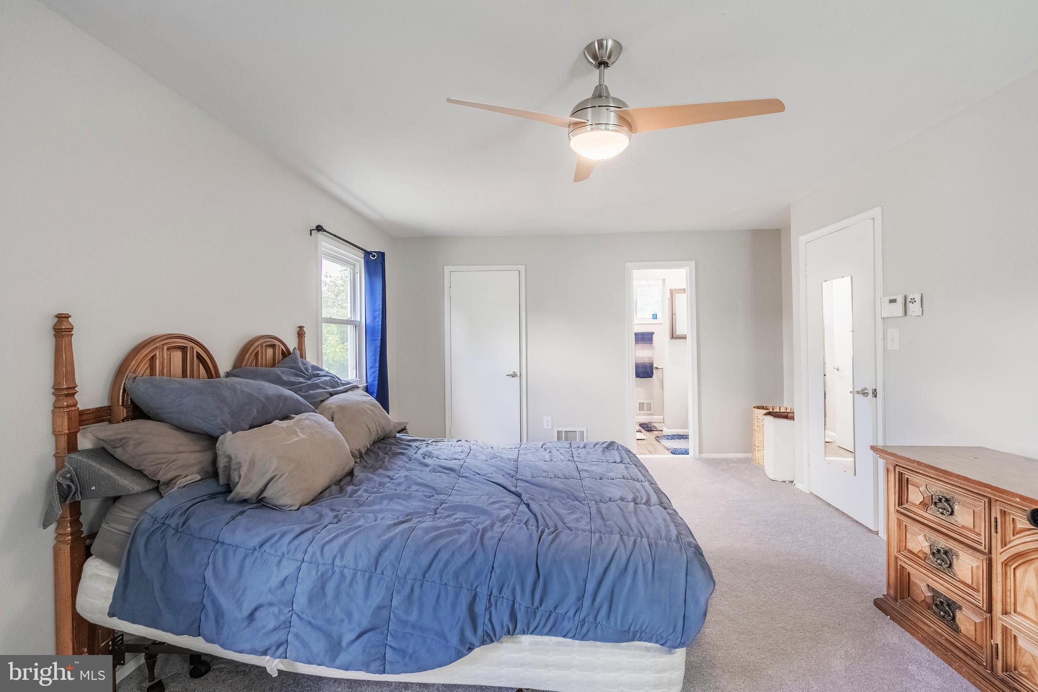 9722 Copeland Drive Manassas, VA 20109 - Photo 44 of 46 a spacious bedroom with a bed and a chandelier