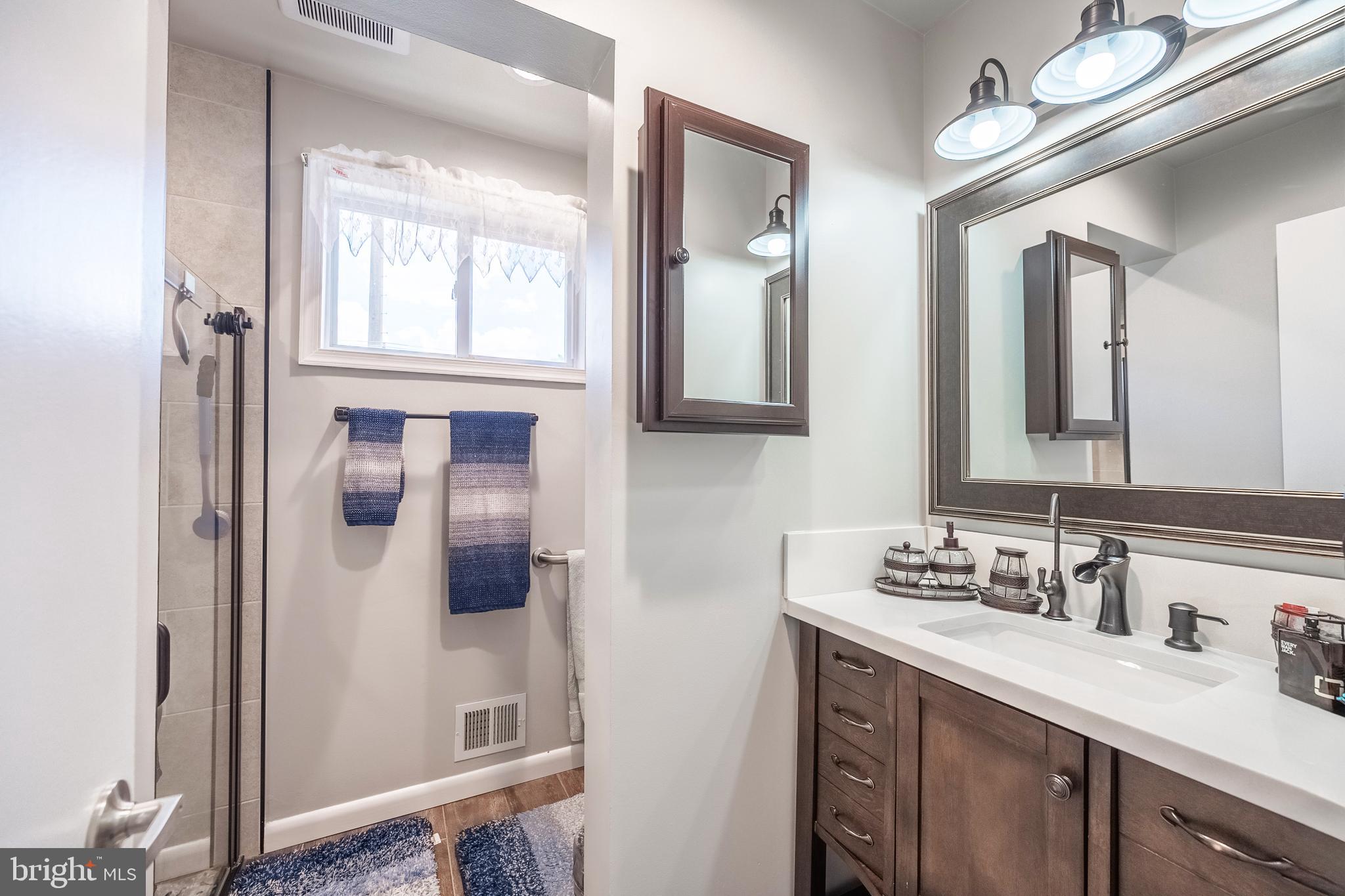 9722 Copeland Drive Manassas, VA 20109 - Photo 45 of 46 a bathroom with a double vanity sink mirror and
