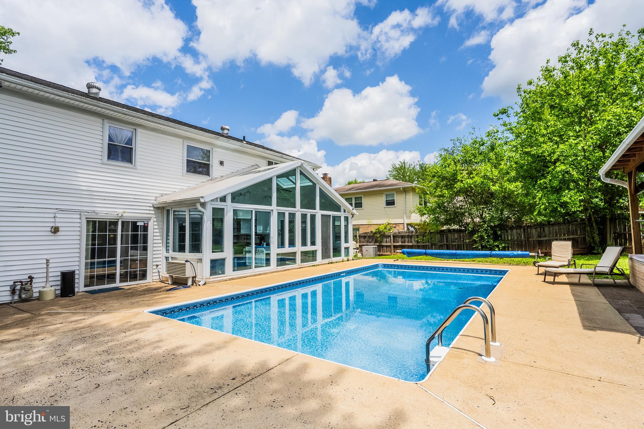 9722 Copeland Drive Manassas, VA 20109 - Photo 9 of 46 a view of a white house with a swimming pool