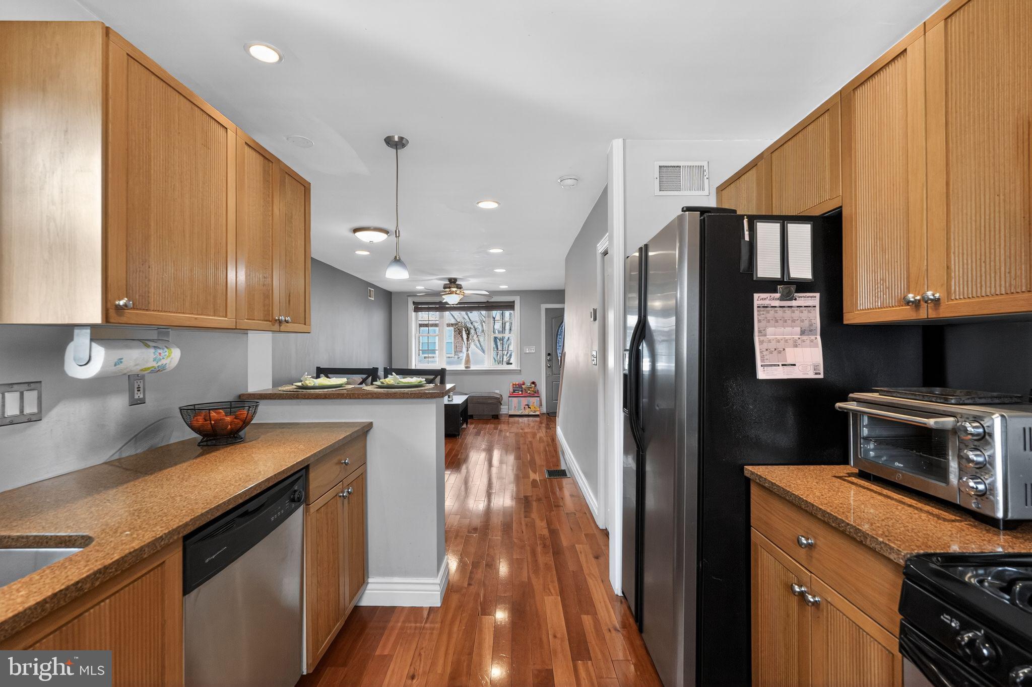 2907 South Sydenham Street Philadelphia, PA 19145 - Photo 4 of 15 a kitchen with a sink a counter space stainless steel appliances and cabinets