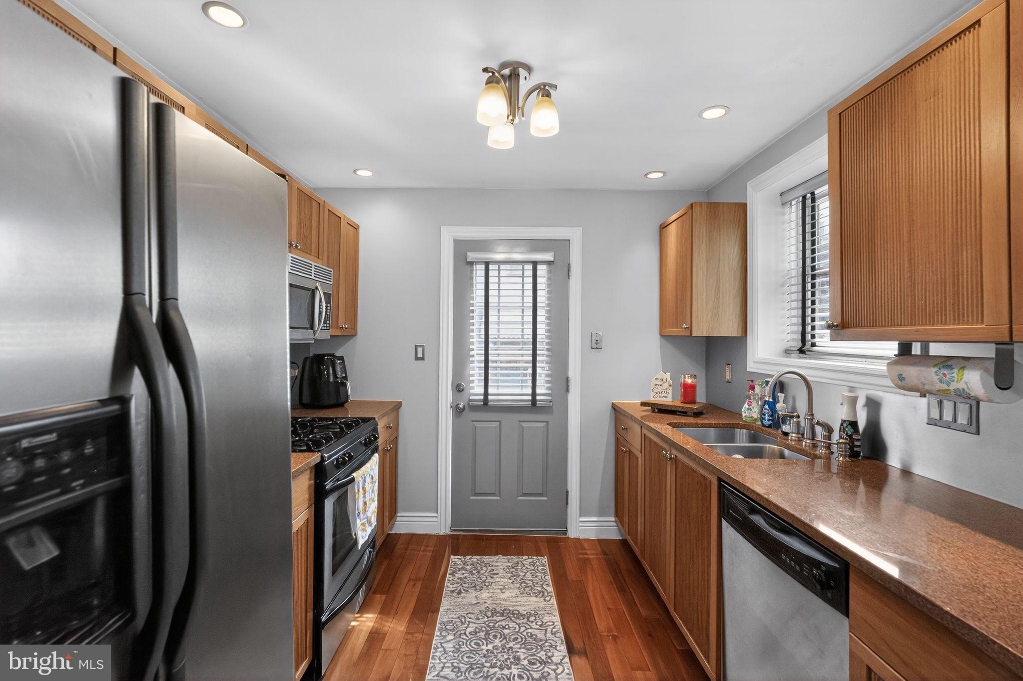 2907 South Sydenham Street Philadelphia, PA 19145 - Photo 5 of 15 a kitchen with stainless steel appliances a sink stove and refrigerator