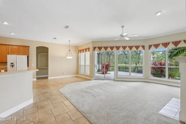 a view of a kitchen with refrigerator and window