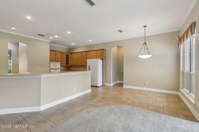a kitchen with a refrigerator and a sink