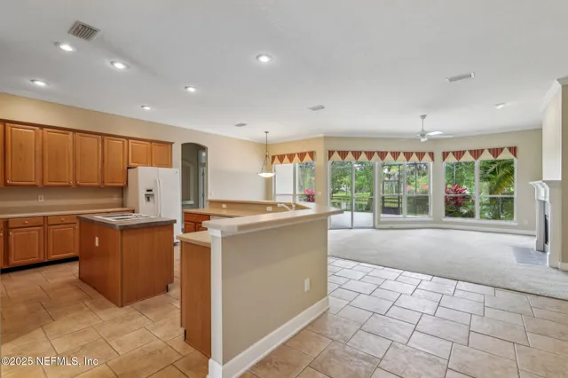 a kitchen with a stove a sink and a refrigerator
