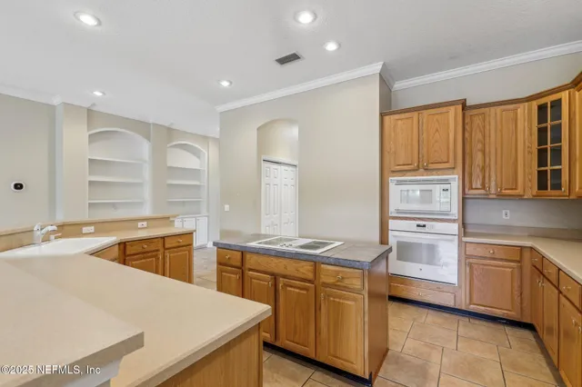 a kitchen that has a sink and a stove