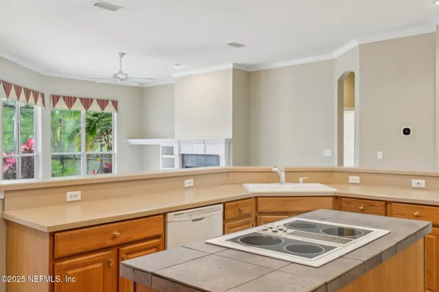 a kitchen that has a sink and a stove in it