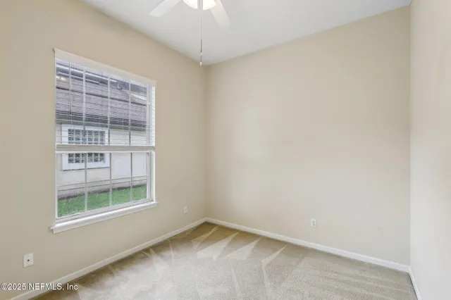 an empty room with a ceiling fan