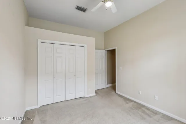 a view of an empty room with glass door