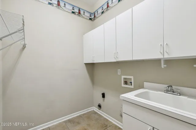 a view of a lake with a yard and large trees