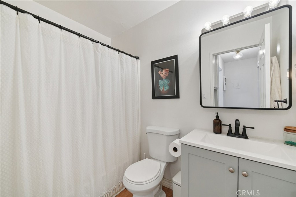 1001 West Stevens Avenue, Unit 318 Santa Ana, CA 92707 - Photo 11 of 19 a bathroom with a toilet a sink and a mirror