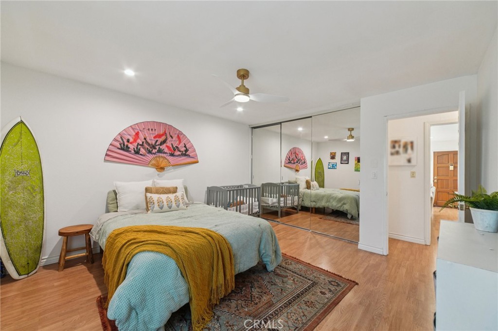 1001 West Stevens Avenue, Unit 318 Santa Ana, CA 92707 - Photo 12 of 19 a bedroom with furniture and a chandelier