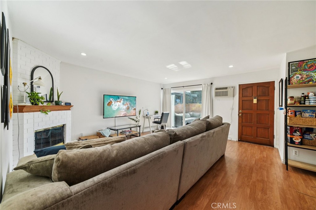 1001 West Stevens Avenue, Unit 318 Santa Ana, CA 92707 - Photo 5 of 19 a living room with furniture and a fireplace