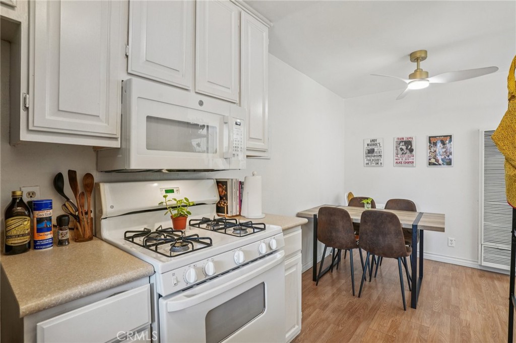 1001 West Stevens Avenue, Unit 318 Santa Ana, CA 92707 - Photo 9 of 19 a kitchen with a stove and white cabinets