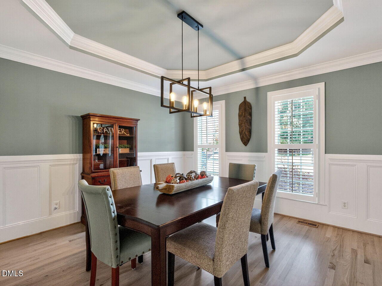 7208 Rippling Stone Lane Raleigh, NC 27612 - Photo 7 of 57 a dining room with furniture a chandelier and wooden floor