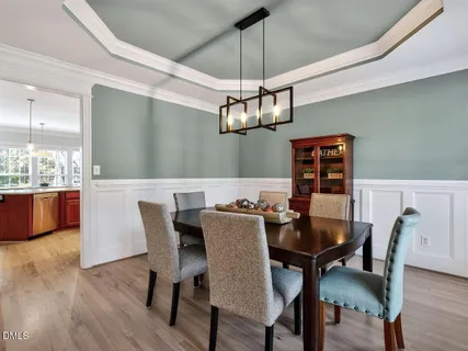 a view of a dining room with furniture wooden floor and chandelier