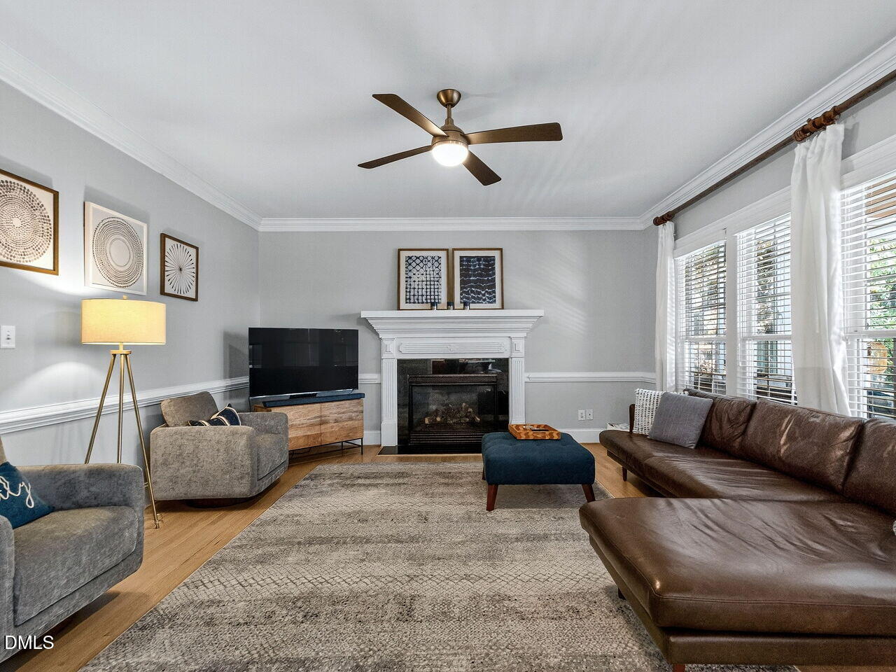 7208 Rippling Stone Lane Raleigh, NC 27612 - Photo 10 of 57 a living room with furniture a fireplace and a flat screen tv