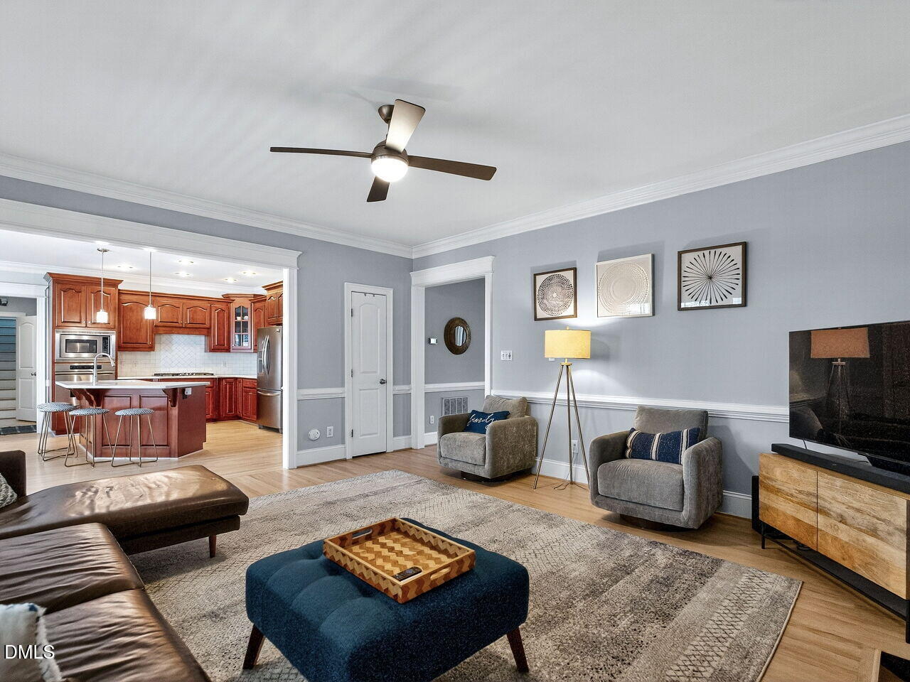 7208 Rippling Stone Lane Raleigh, NC 27612 - Photo 12 of 57 a living room with furniture and a flat screen tv