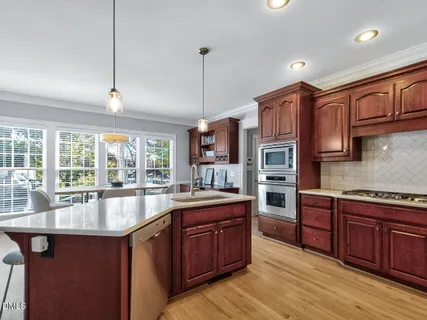 a kitchen with wooden cabinets and a sink