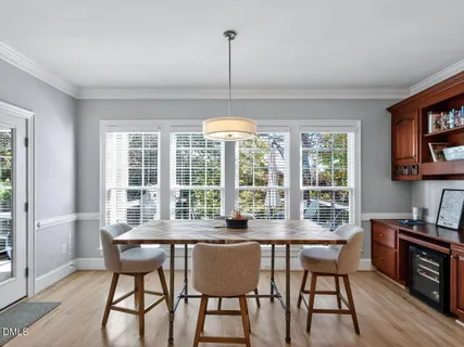a dining room with furniture a chandelier and wooden floor