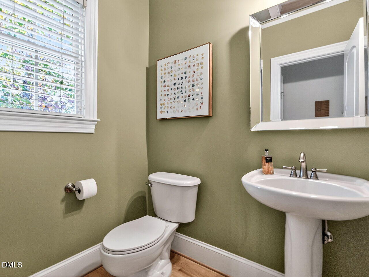 7208 Rippling Stone Lane Raleigh, NC 27612 - Photo 21 of 57 a bathroom with a toilet a sink and mirror