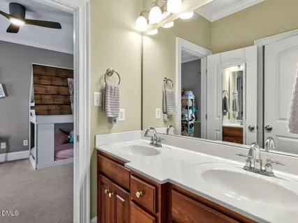 a bathroom with a sink double vanity and a mirror