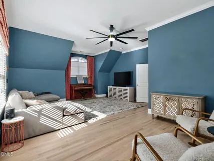 a bedroom with furniture and a wooden floor