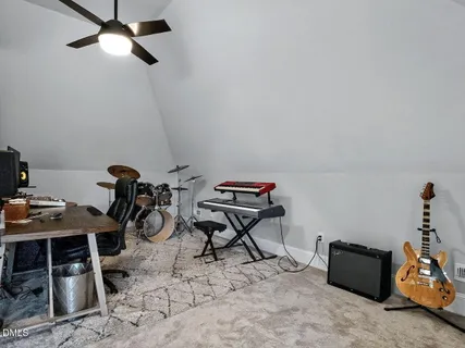 a living room with furniture and a air conditioner vent