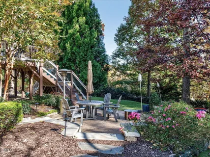 a view of backyard with table and chairs and potted plants
