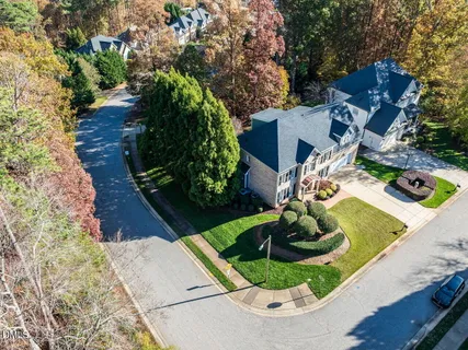 an aerial view of house with yard swimming pool and outdoor seating