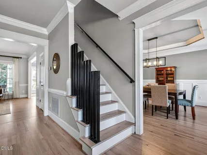 a view of entryway and hall with wooden floor