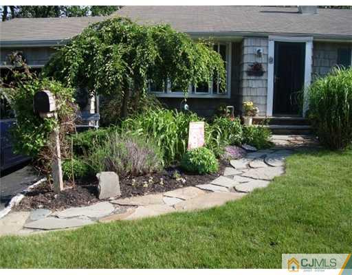 51 Westminster Road Colonia, NJ 07067 - Photo 2 of 25 a view of a house with a yard and sitting area